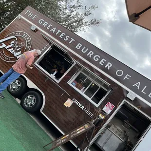 a man standing in front of a food truck