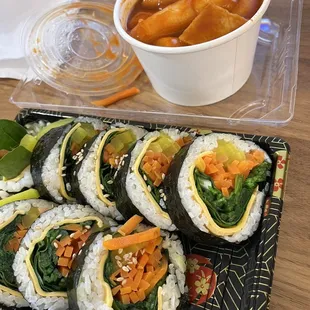 a plate of sushi and a bowl of soup