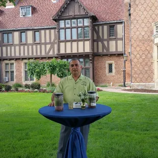 a man sitting at a table in front of a building