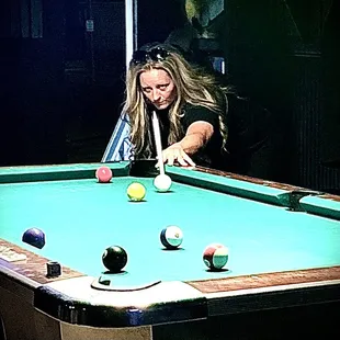 a woman playing pool