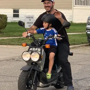 Candid photo of Father &amp; Son rising by, while waving, during the 100th year anniversary!