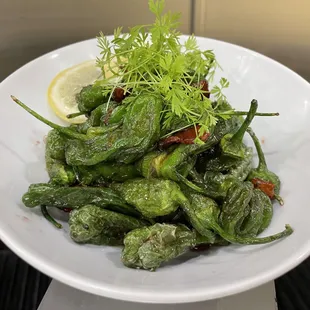 Blistered Shishito peppers in a balsamic pomegranate reduction