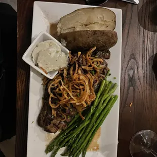 Rib-eye steak, with sautéed mushrooms and onions, asparagus and baked potato.
