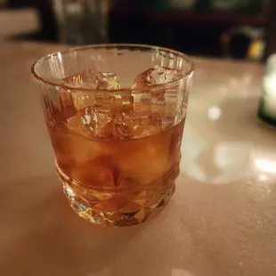 a glass of whiskey on a table