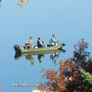 three men fishing in a boat