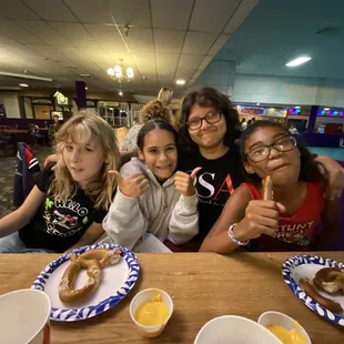 My kid and her friends. Eating pretzel with cheese.