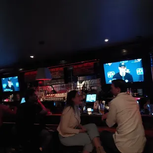 a group of people sitting at a bar