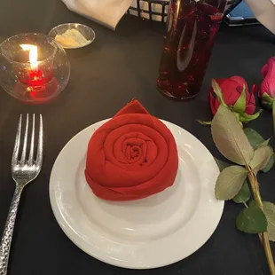 Rose on the place !! was  a red cloth napkin  made into a Rose shape !! Nice touch !! Loved it all