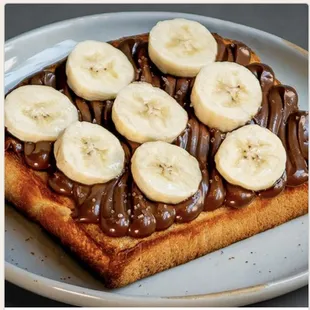 chocolatey hazelnut spread, sliced bananas, and sea salt on shokupan toast or scratch-baked buttermilk biscuit