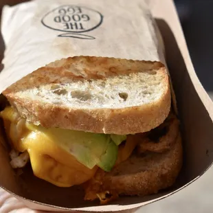 a hand holding a sandwich