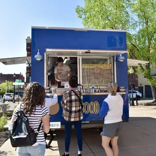 people ordering food from a food truck