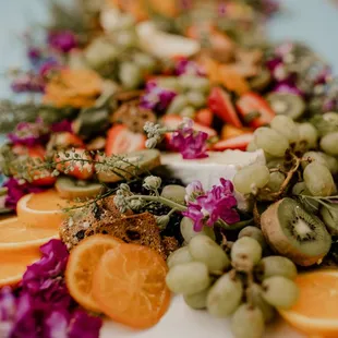 an arrangement of fruit and flowers