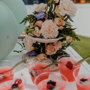 a table with drinks and flowers