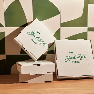 two pizza boxes stacked on top of each other