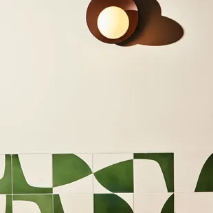 a green and white tiled wall