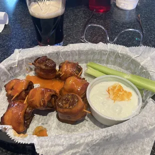 a basket of chicken wings with a side of celery