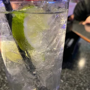  glass of water with ice and a lime slice