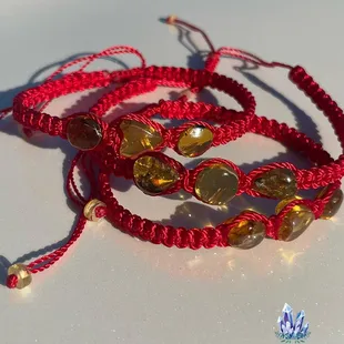 Red yarn Mexican Amber bracelets. Great for protection, relief of joint pain and muscle aches, grounding and clearing sacral chakras.