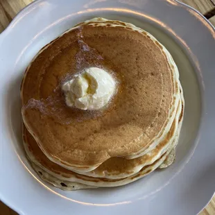 classic buttermilk pancakes - three of them with pure maple syrup