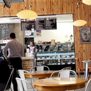 people sitting at tables in a cafe