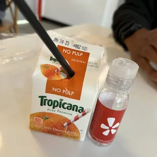 a carton of tropicana juice and a bottle of liquid