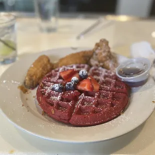 a waffle with strawberries and blueberries