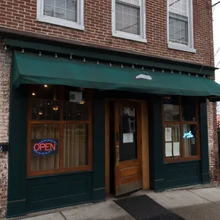 a brick building with a green awning