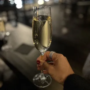 a woman holding a glass of wine