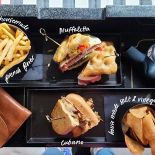 over view of lunch; sandwiches, fries, and salt &amp; vinegar chips