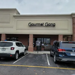 two cars parked in front of the store