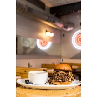 a beef sandwich and a cup of coffee