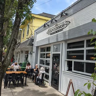 Outside view.  A few tables in front.