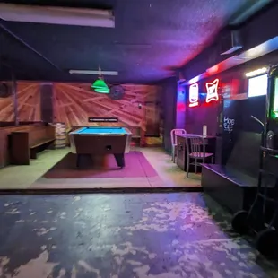 a pool table and arcade machines