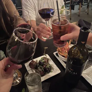 Papás locas, bottle of wine, pork belly bites