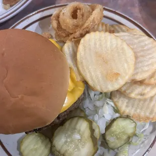 a hamburger, pickles, onion rings and onion rings
