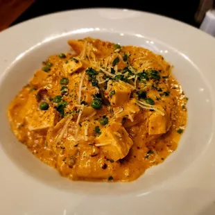 House made seafood ravioli with grilled chicken and crab sauce