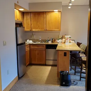 Kitchen/bar area. Full size fridge, microwave, stove and dishwasher.