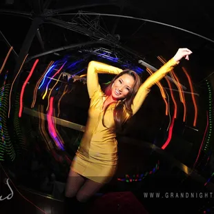 a woman in a yellow dress dancing