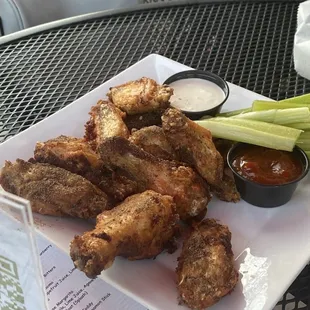 a plate of chicken wings and celery