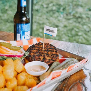 a tray of food and a bottle of beer