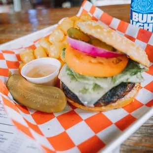 a cheeseburger with pickles and a pickle