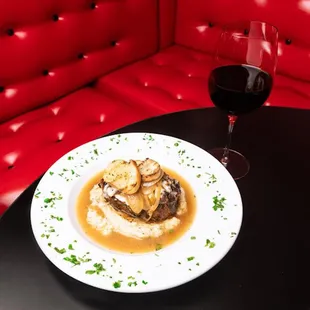 a plate of food and a glass of wine