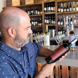 a man opening a bottle of wine