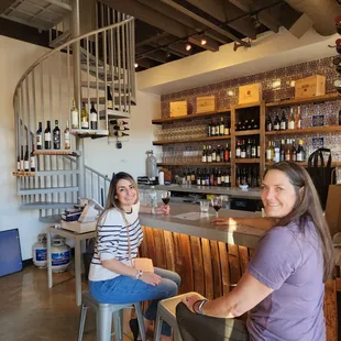 two women sitting at the bar