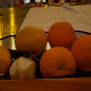 a bowl of oranges and lemons