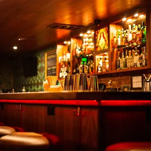 a dimly lit bar with stools