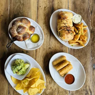 three plates of food on a wooden table