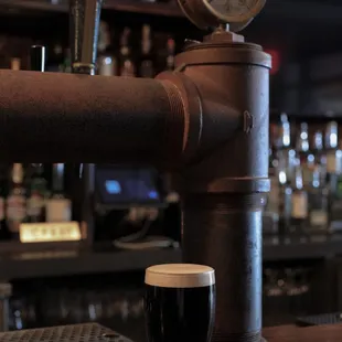 a pint of beer next to a gauge