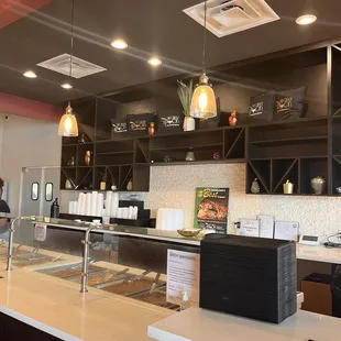 a kitchen with a counter and shelves