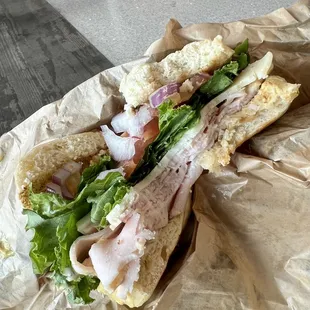 Wayyy better than I expected turkey, lettuce, tomato, onion, mayo, Dijon mustard, and Swiss cheese on cheese/jalapeño bagel sandwich.